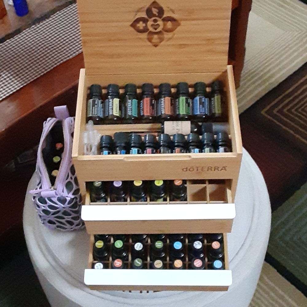 Doterra oils, rollers, wood box, and purple case